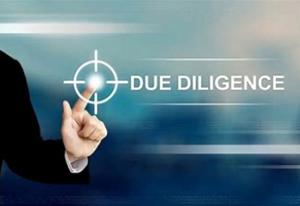 A hand pointing to the word due diligence on a screen.